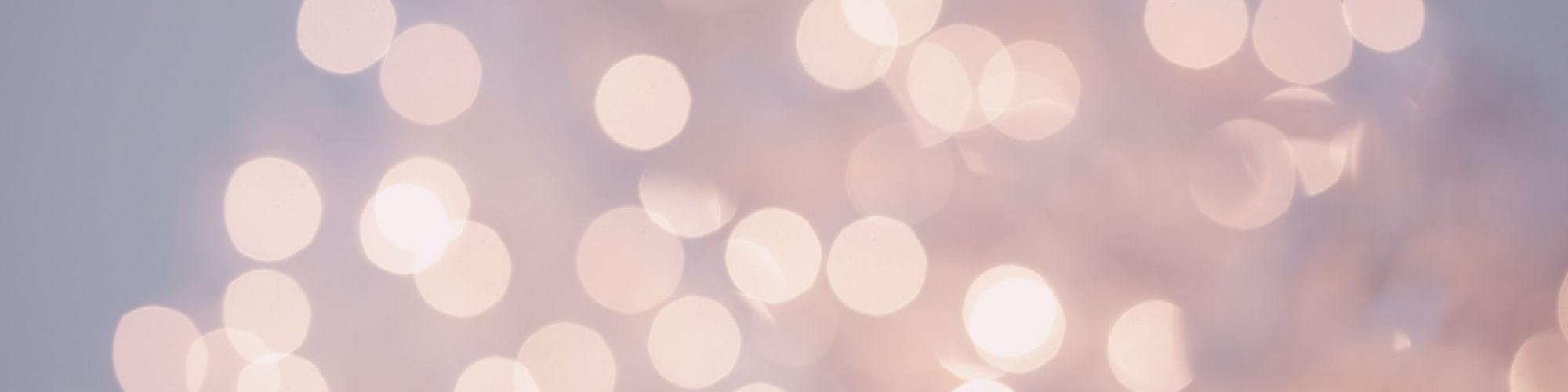 The image shows soft-focused lights creating a bokeh effect against a dusky sky.
