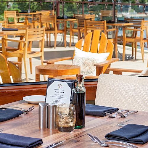 Outdoor dining setup with neatly arranged tables, chairs, and a menu.