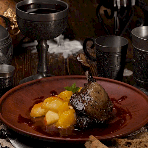 The image shows a rustic setting with lit candles, goblets, and a plate of cooked meat with potatoes, creating a medieval dining atmosphere.